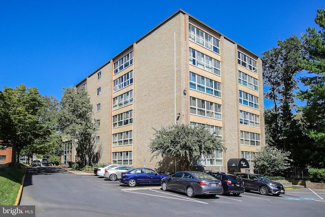 view of building exterior with uncovered parking