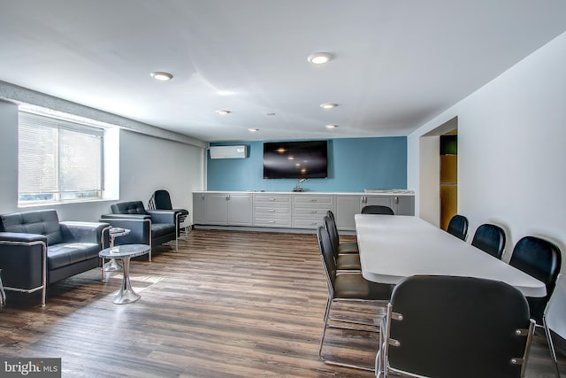 dining area featuring wood finished floors, recessed lighting, and a wall mounted AC