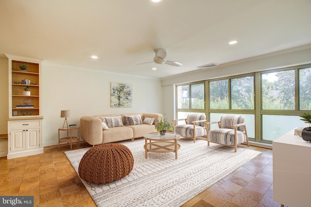 living room with crown molding, a ceiling fan, and recessed lighting