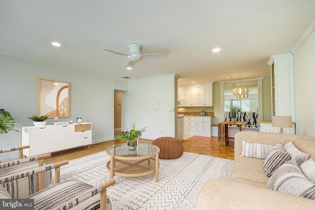 living area featuring crown molding, a ceiling fan, baseboards, and recessed lighting