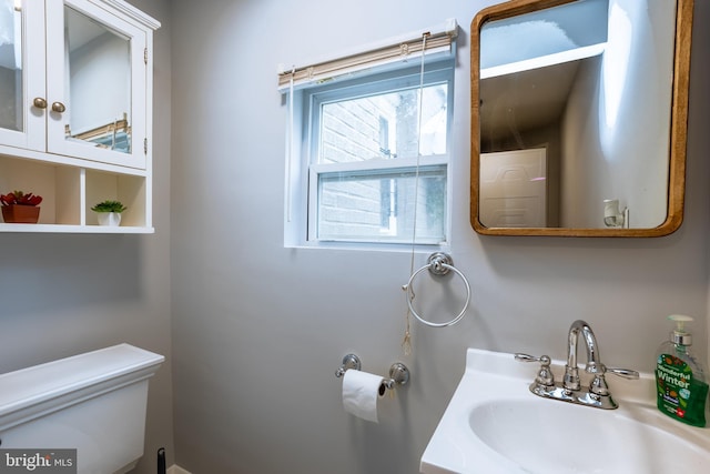 half bath with a sink and toilet