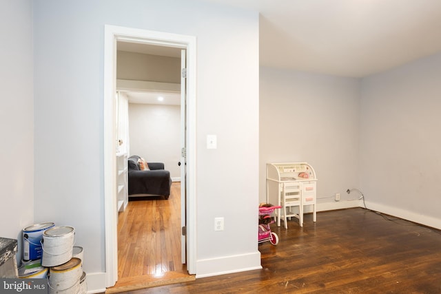 recreation room featuring baseboards and wood-type flooring