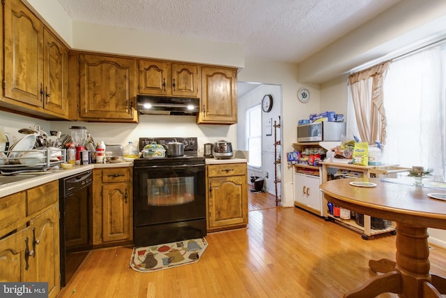 500 Kegworth Ct, Severna Park, MD 21146 - kitchen with under cabinet range hood, brown cabinets, and black appliances
