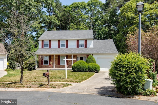 500 Kegworth Ct, Severna Park, MD 21146 - traditional home with a porch, a garage, brick siding, a front lawn, and driveway