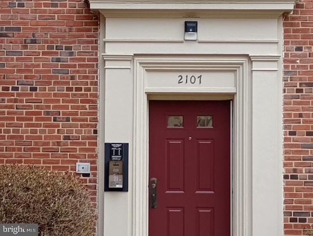 view of exterior entry with brick siding