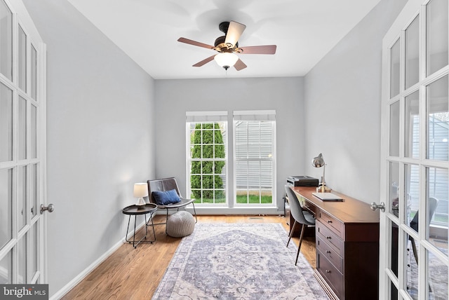 office featuring baseboards, ceiling fan, and wood finished floors