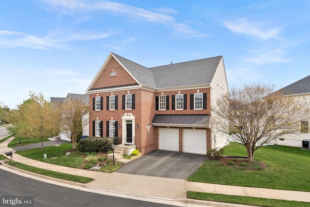view of front facade featuring aphalt driveway, central air condition unit, brick siding, a front lawn, and an attached garage
