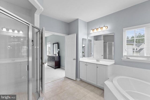 bathroom featuring tile patterned flooring, a shower stall, a bath, and vanity