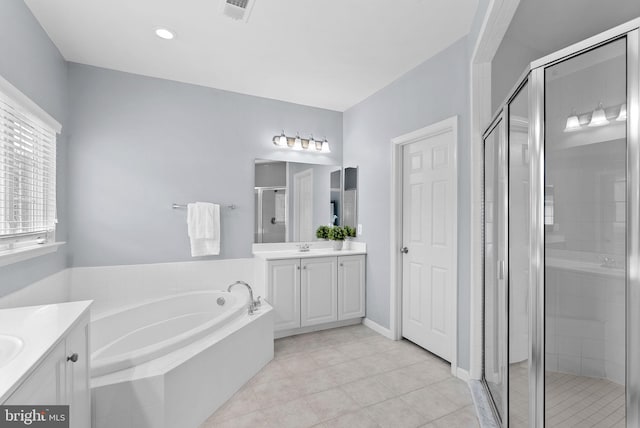 full bath featuring vanity, a shower stall, a bath, and visible vents