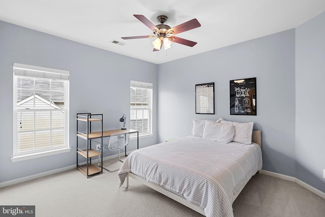 bedroom with carpet flooring, a ceiling fan, baseboards, and visible vents