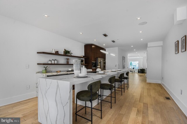 2515 Ontario Rd NW Unit 1, Washington, DC 20009 - kitchen with open shelves, freestanding refrigerator, modern cabinets, a large island, and light wood finished floors
