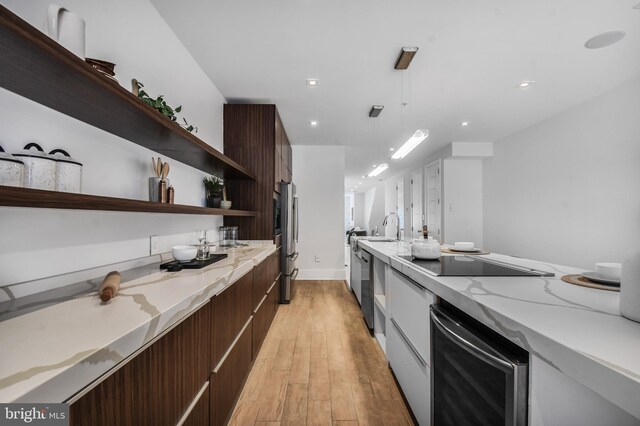 2515 Ontario Rd NW Unit 1, Washington, DC 20009 - kitchen featuring open shelves, modern cabinets, beverage cooler, light wood-style floors, and dark brown cabinets