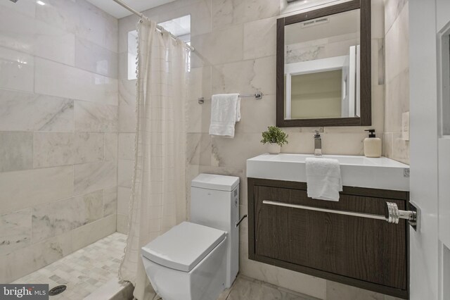 2515 Ontario Rd NW Unit 1, Washington, DC 20009 - bathroom with tile walls, toilet, vanity, and a tile shower