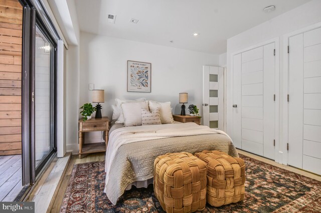 2515 Ontario Rd NW Unit 1, Washington, DC 20009 - bedroom with hardwood / wood-style flooring, multiple windows, and recessed lighting