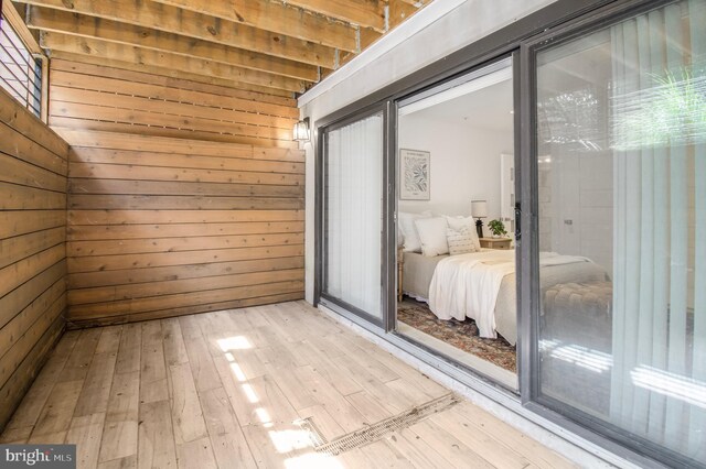 2515 Ontario Rd NW Unit 1, Washington, DC 20009 - bedroom featuring light wood finished floors and wooden walls