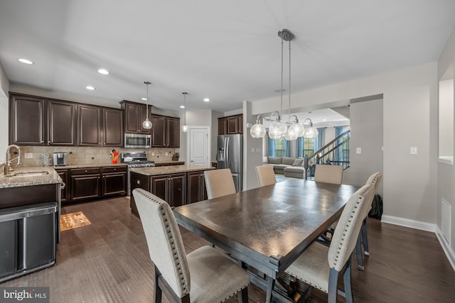 dining area with recessed lighting, baseboards, stairway, and dark wood-type flooring