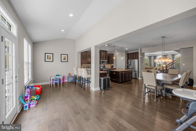 interior space with a notable chandelier, recessed lighting, baseboards, vaulted ceiling, and dark wood-style floors