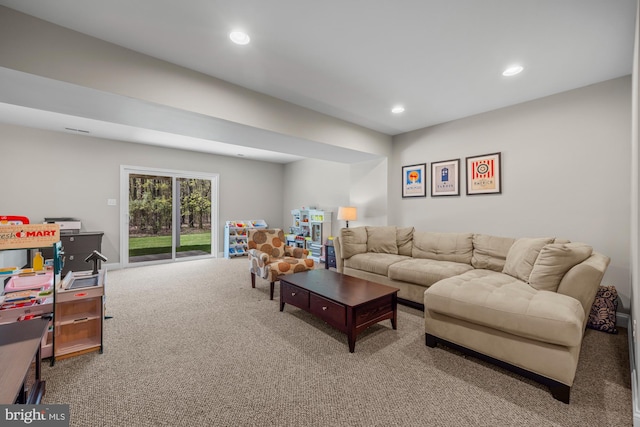 carpeted living area with recessed lighting