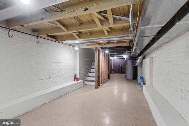 unfinished basement with water heater and stairs