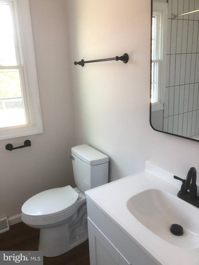 bathroom with visible vents, toilet, and vanity