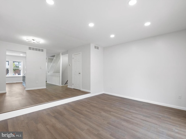 basement featuring baseboards, wood finished floors, visible vents, and recessed lighting