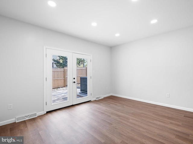 unfurnished room with wood finished floors, french doors, visible vents, and recessed lighting