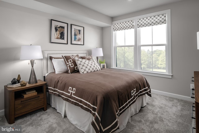 bedroom featuring baseboards and light carpet