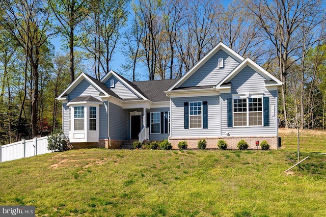 view of front of home with a front lawn and fence
