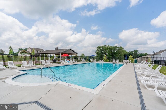 community pool featuring a patio area and fence