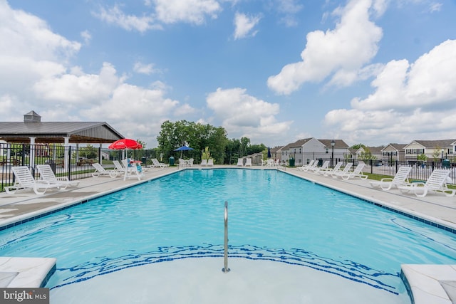 pool with fence and a patio