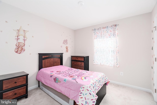 carpeted bedroom featuring baseboards
