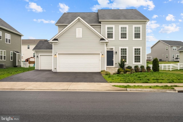 traditional-style home with central AC unit, driveway, and fence