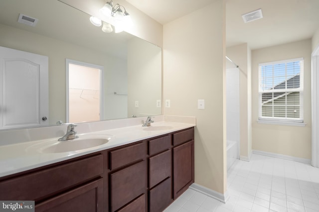full bathroom featuring double vanity, visible vents, and a sink