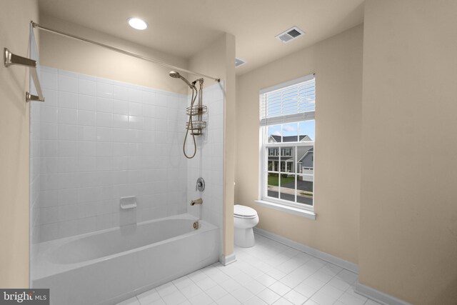 full bath with shower / washtub combination, tile patterned flooring, visible vents, toilet, and baseboards