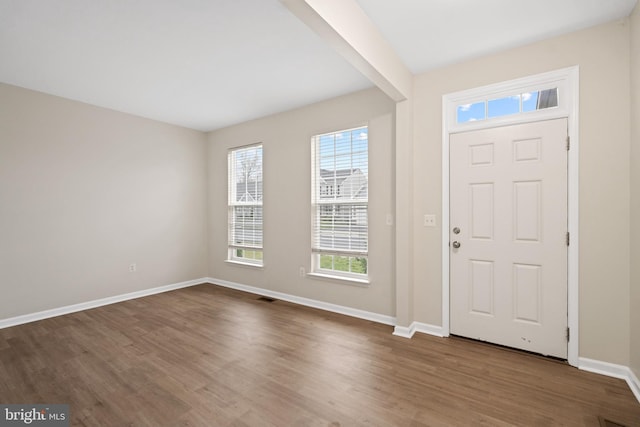 entrance foyer with visible vents, baseboards, and dark wood finished floors