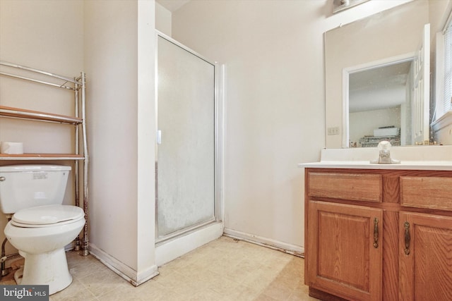 full bathroom with a shower stall, vanity, and toilet