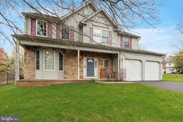 traditional home featuring driveway, stone siding, a front lawn, a porch, and fence