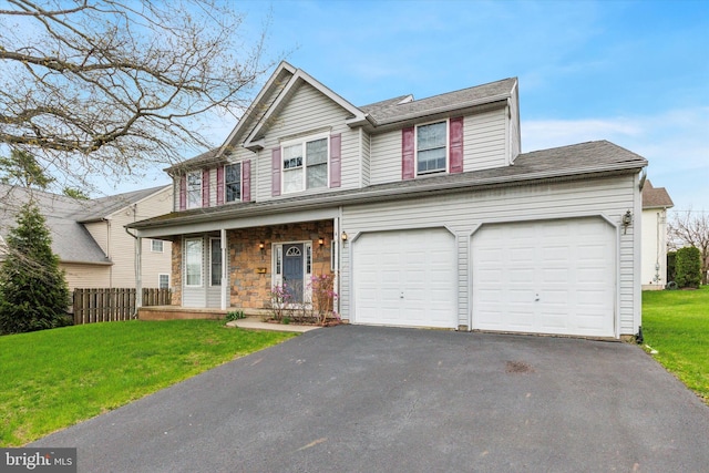 view of front of property featuring driveway, an attached garage, a front yard, a porch, and fence