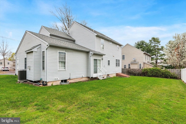 back of property featuring a shingled roof, a yard, entry steps, fence, and central air condition unit