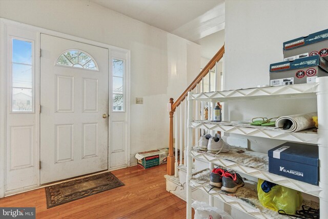 foyer entrance with stairway and wood finished floors