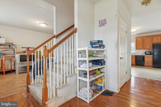 stairs featuring baseboards and hardwood / wood-style flooring