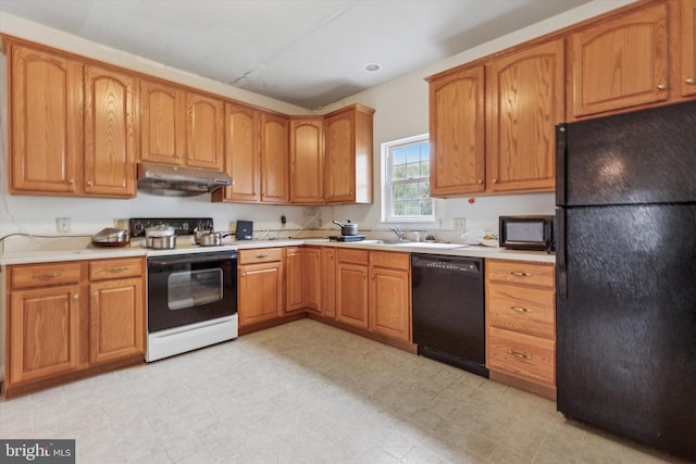 kitchen with black appliances, under cabinet range hood, a sink, light countertops, and brown cabinets
