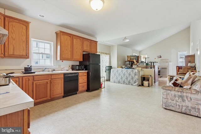 kitchen with open floor plan, light countertops, lofted ceiling, and black appliances
