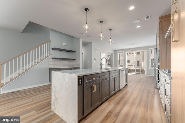 350 Star Tavern Ln, West Chester, PA 19382 - kitchen with light wood finished floors, an island with sink, visible vents, a sink, and baseboards