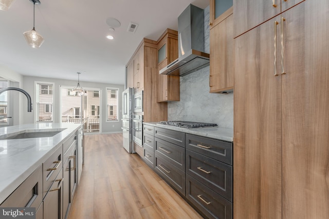 350 Star Tavern Ln, West Chester, PA 19382 - kitchen with wall chimney range hood, a sink, stainless steel appliances, light wood-style flooring, and visible vents