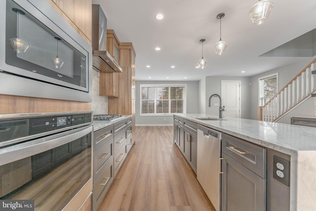 350 Star Tavern Ln, West Chester, PA 19382 - kitchen with a sink, light wood-style floors, light stone countertops, wall chimney exhaust hood, and appliances with stainless steel finishes