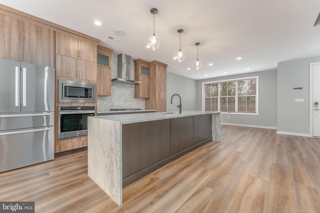 350 Star Tavern Ln, West Chester, PA 19382 - kitchen featuring wall chimney range hood, tasteful backsplash, a sink, baseboards, and appliances with stainless steel finishes