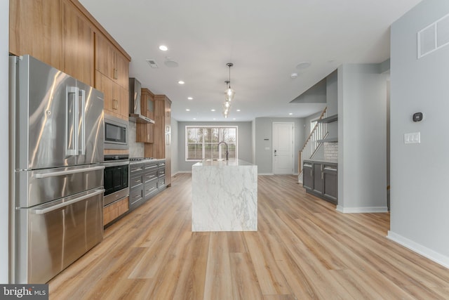 350 Star Tavern Ln, West Chester, PA 19382 - kitchen with light wood finished floors, light stone counters, visible vents, baseboards, and appliances with stainless steel finishes