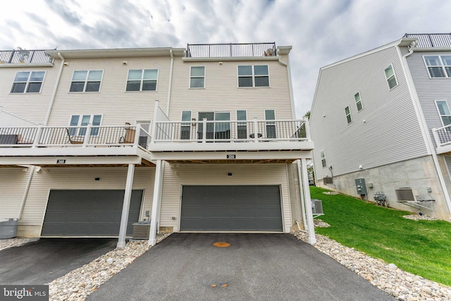 350 Star Tavern Ln, West Chester, PA 19382 - back of house featuring an attached garage, a lawn, driveway, and central AC