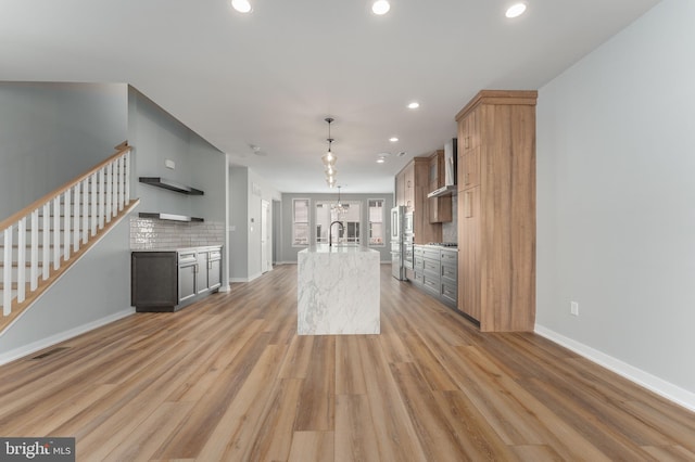 350 Star Tavern Ln, West Chester, PA 19382 - kitchen with wall chimney exhaust hood, light wood-style flooring, a sink, and tasteful backsplash